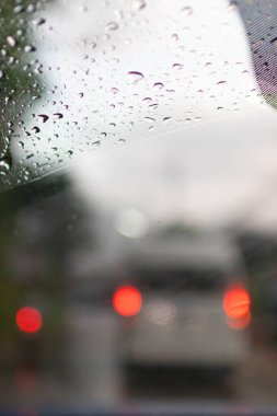 Soft Focus,Raindrops on the windshield are raindrops created by a passing storm and affect visibility when driving on the road because raindrops on the windshield make vision difficult.