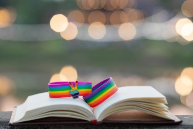 rainbow wristband is symbol for lgbtq or lgbtqia groups that unite to advocate for rights of LGBTQ people to have rights and freedoms in society and use colorful rainbow as symbol of lgbtq