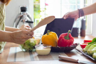 young woman preparing bell Pepper as a breakfast ingredient and ready for healthy cooking and on the table there are vegetables that are healthy organic ingredients. healthy food preparation ideas