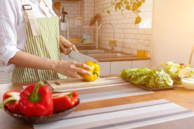young woman preparing bell Pepper as a breakfast ingredient and ready for healthy cooking and on the table there are vegetables that are healthy organic ingredients. healthy food preparation ideas