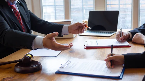 stock image Trading documents and joint venture documents are brought to the investors to sign together within the legal counsel's office because the documents to be signed must be witnessed with the signing.
