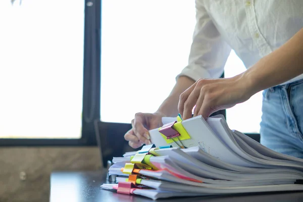 stock image Businesswoman hands working on stacks of paper documents to search and review documents piled on table before sending them to board of directors to use  correct documents in meeting with Businessman