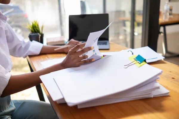 stock image Businesswoman hands working on stacks of paper documents to search and review documents piled on table before sending them to board of directors to use  correct documents in meeting with Businessman