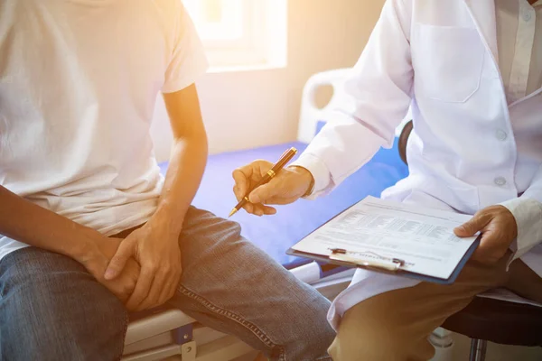 doctor is having consultation discussing prostate cancer and venereal cancer detected in young man. Current doctors provide advice and counseling on detecting prostate cancer and treating it properly.