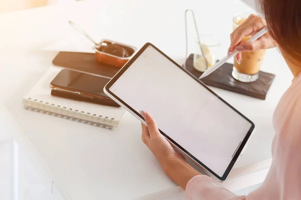 stock image Young Asian businesswoman using laptop and notebook computers to work through internet to collect and organize investment documents. young businesswoman concept using technology to help investment