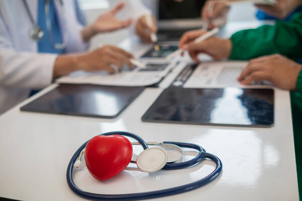 concept of medical team meeting to discuss about treating heart disease with surgery and preventing recurrence of heart disease later. medical team meeting about cardiology to treat patients.