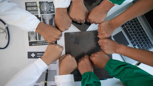 stock image The medical team joins hands after the meeting and discusses the treatment of severely ill patients and can come to a conclusion on the surgical treatment of the patient. Medical team meeting concept