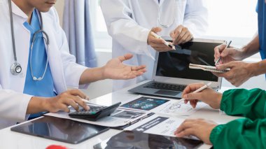 Tıp ekibinin konferans odasında hastalıkları teşhis etme ve tedavi etme yeteneğini harekete geçirme kavramı. Tıbbi ekip toplantıya katılır ve hasta hastalığını doğru şekilde tedavi etmek için tartışır.