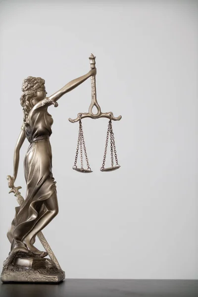 Stock image statue of god Themis Lady Justice is used as symbol of justice within law firm to demonstrate truthfulness of  facts and power to judge without prejudice. Themis Lady Justice is of justice.