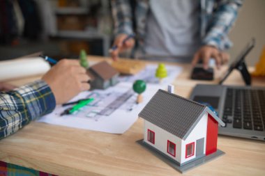 Mimarlar ve mühendisler, inşaatın standartlara uygun ve zamanında tamamlandığından emin olmak için konut inşaatının nasıl tasarlanacağını tartışıyor. Mühendisler ve mimarlardan oluşan bir ekip bina tasarımı ve yapısını tartıştı.