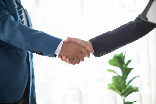 Businessmen and investors shake hands after attending  meeting with advisory team after receiving advice from  advisory team about jointly invested business. Businessmen Team handshake concept