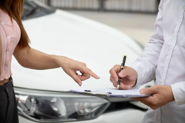 car dealer brings sales contract for customer to sign after customer has selected car they want and agreed to buy car with dealer. concept of entering into a sales contract with a trusted distributor