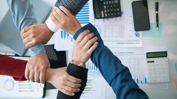 Businessmen and investors join hands symbolize friendship and cooperation in business success. concepts of group of businessmen and investors joining hands symbolize cooperation in doing business.