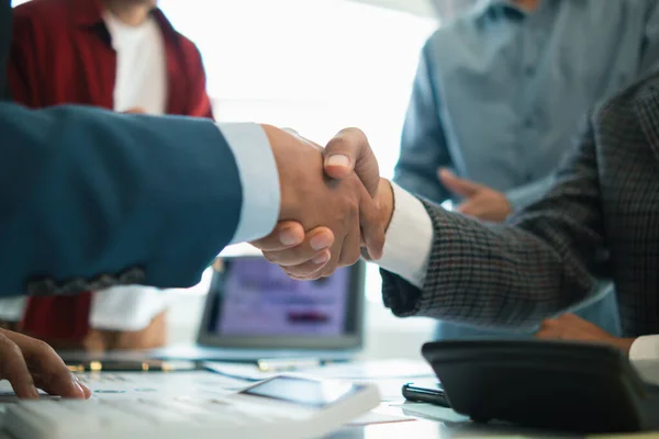 Businessmen and investors join hands symbolize friendship and cooperation in business success. concepts of group of businessmen and investors joining hands symbolize cooperation in doing business.
