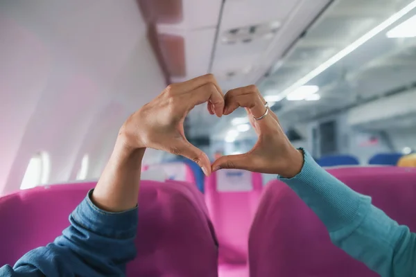 lover raises her hands and makes heart symbol express meaning of love friendship and kindness towards her friend and lover. couple uses their hands to make heart symbol that means love and friendship.