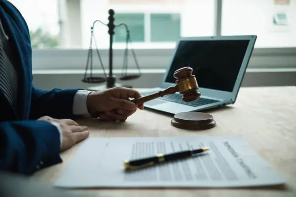judge holds givel wood tapped on the wooden base to read verdict for victims and defendants to know the verdict obtained from the evidence and the lawyer\'s defense of the case. court decision concept