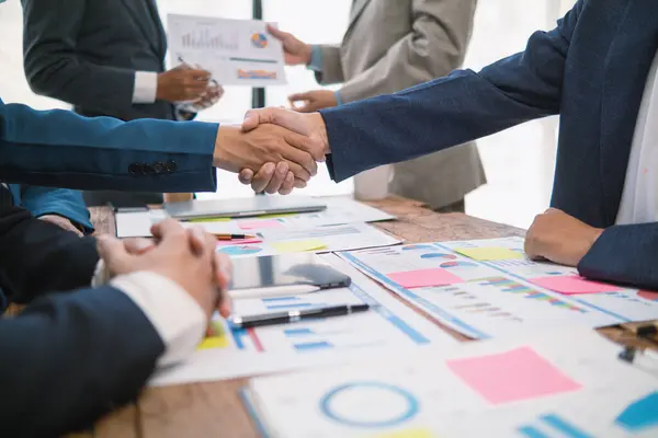 stock image committee of businessmen and investors join hands as symbol of joint investment after discussing consulting and making contract  invest in business together. committee joins hands in meeting.