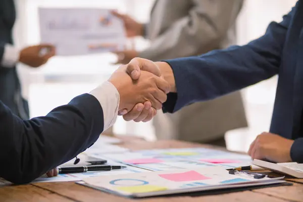 stock image committee of businessmen and investors join hands as symbol of joint investment after discussing consulting and making contract  invest in business together. committee joins hands in meeting.