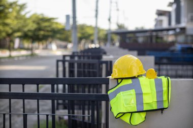 Yellow safety helmet are provided along with reflective vests for workers wear because Yellow safety helmets protect against falling objects during construction and reflective vests provide visibility clipart