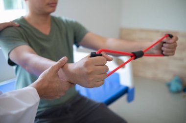 Doktor kas hasarını inceliyor ve elastik bant test yaralanması kullanıyor ve ayrıca fiziksel terapi ile kasları güçlendiriyor çünkü fizik tedavi kasların güçlenmesine ve kan akışının artmasına yardımcı olacak..