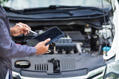 car service center mechanics are checking condition car and engine make sure they are ready use and in perfect condition according center warranty. periodic vehicle inspections for safety in driving. clipart