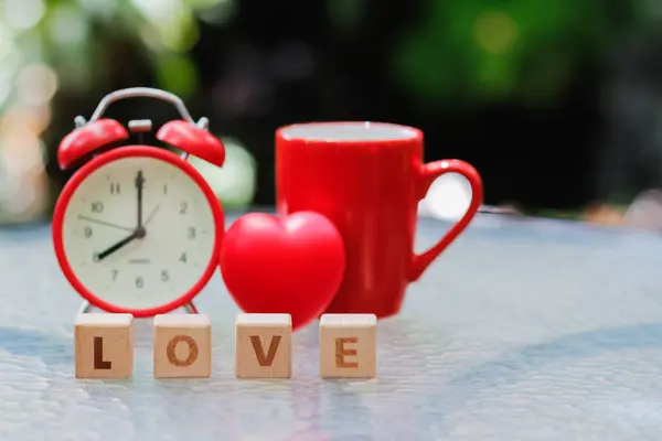 stock image wooden blocks with word love are arranged to indicate meaning I love you and are also symbol of love and friendship for one another. Wooden blocks with word love are arranged on glass table.