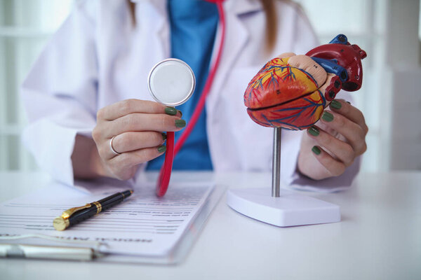 Doctors use stethoscope to listen patient heartbeat to find faults in heart disease. Doctors use stethoscope to listen patient heart rate to gather information diagnose disease and provide treatment.