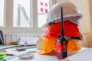 Work equipment placed on desk in office of team of engineers and architects design large construction project to meet needs of investors and check feasibility of project by an architect with expertise clipart