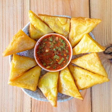 Golden fried tofu looks delicious It is Tai Yai food that uses winged beans as an ingredient making it healthy fried food and popular as snack. Fried tofu with spicy dipping sauce is snack for Tai Yai clipart