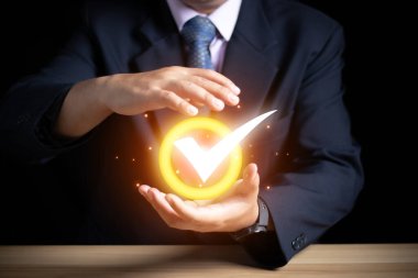 Businessman Hand shows the sign of the top service the best Quality assurance, Guarantee, Standards, ISO certification and standardization concept. guarantee product and ISO service concept.