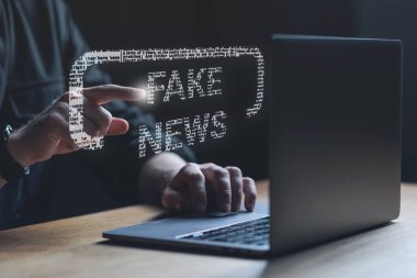 Fake news concept. Man points at Fake news text. High quality photo clipart