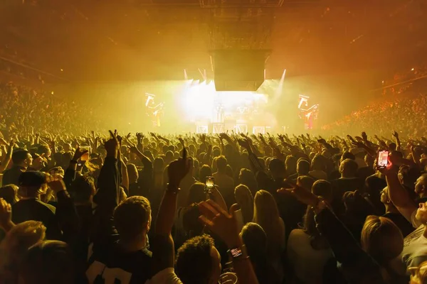 Big people crowd cheering and dancing in huge concert. High quality photo