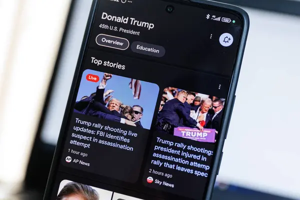 Stock image Donald Trump rally shooting shown on google news page displayed on smartphone screen. High quality photo