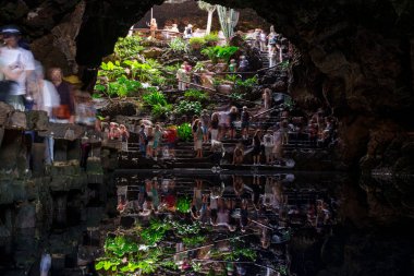 Yeraltı volkanik mağaralarını ve İspanya 'nın Kanarya Adaları, Lanzarote kentindeki Jameos del Agua' daki yansıtıcı doğal lagünü ziyaret eden turistler. 17 Mart 2025