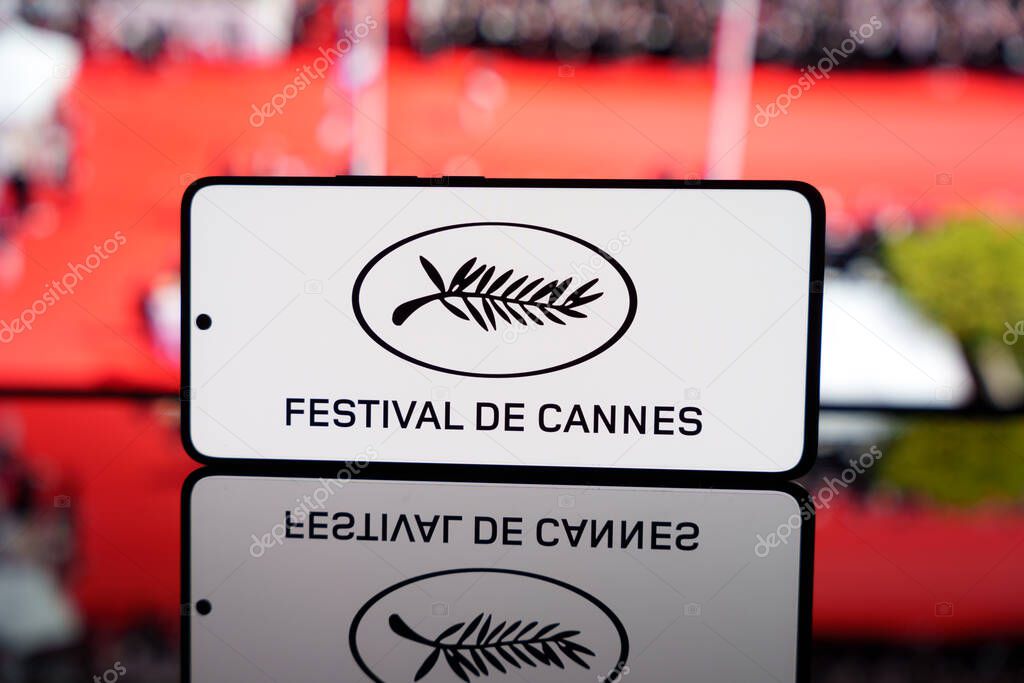 Smartphone displaying Roland Garros logo with blurred clay court in background. French Open tennis tournament concept. March 17, 2025