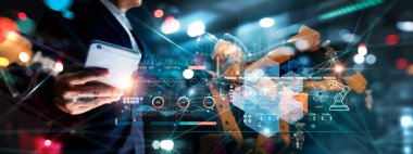 Technician manager, Industrial engineer control robotics on monitoring system software and icon industry network connection on smartphone. AI. Automation robot arm in smart factory. Industry 4.0