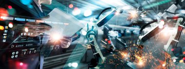 Industrial engineer, Technician manager control robotics on monitoring system software and icon industry network connection on tablet. AI. Automation robot arm machine in smart factory. Industry 4.0