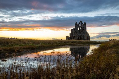 Sunset view of Whitby abbey overlooking the North Sea on the East Cliff above Whitby in North Yorkshire, England, UK clipart