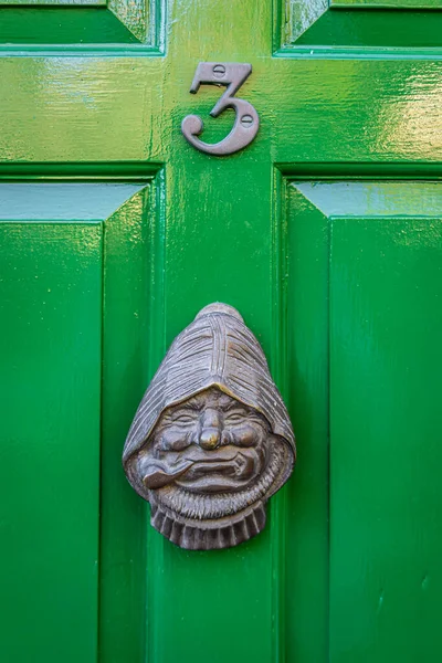A green door in Robin Hood\'s Bay, a picturesque old fishing village on the Heritage Coast of the North York Moors, UK