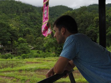 young man in the bamboo bridge of pai thailand