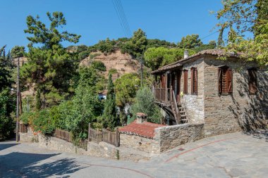 Nikiti, Greece, July 20, 2024. Street of the old town of Nikiti with its stone houses. clipart