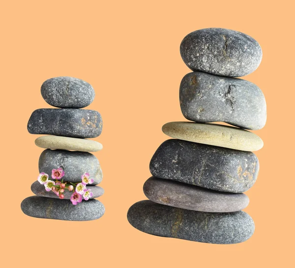 Balancing stone or rock isolated, natural pebble with clipping path, no shadow in cream background