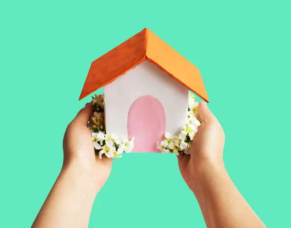 Handmade paper house isolated with clipping path, no shadow in green background