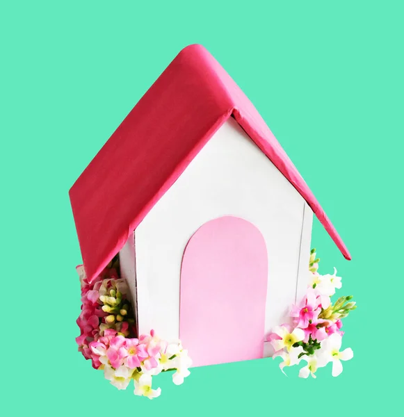 Handmade paper house isolated with clipping path, no shadow in green background