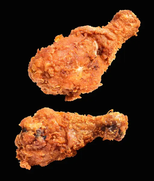 Crispy fried chicken leg drumstick isolated with clipping path, no shadow in black background, fast food
