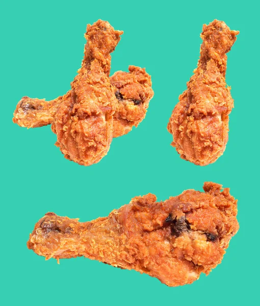 Crispy fried chicken leg drumstick isolated with clipping path, no shadow in mint background, fast food