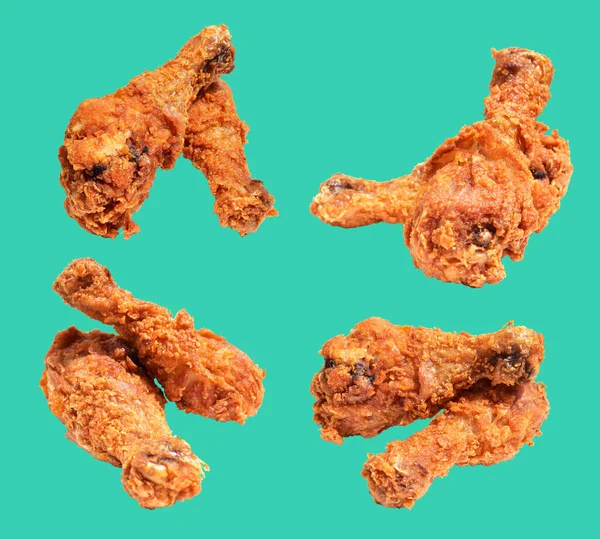 Crispy fried chicken leg drumstick isolated with clipping path, no shadow in mint background, fast food