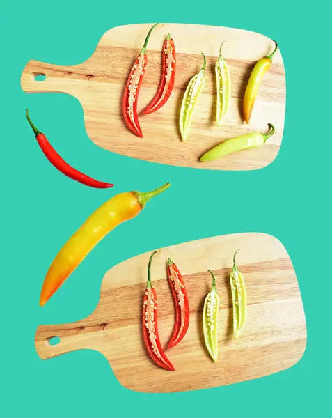Red hot chili pepper isolated on wood cutting board in mint background, no shadow with clipping path, natural seasoning, cooking ingredient