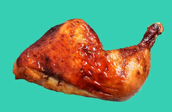 Grilled chicken quarter leg with sauce isolated, clipping path, no shadow in green background
