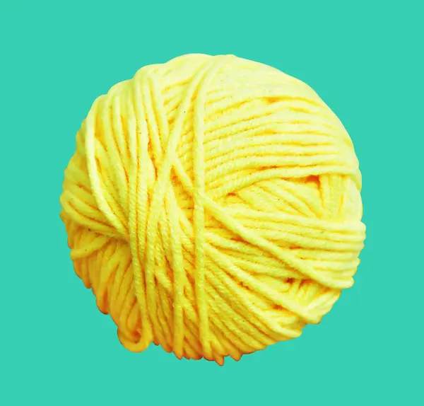 Pastel yellow ball of wool isolated with clipping path, no shadow in green background